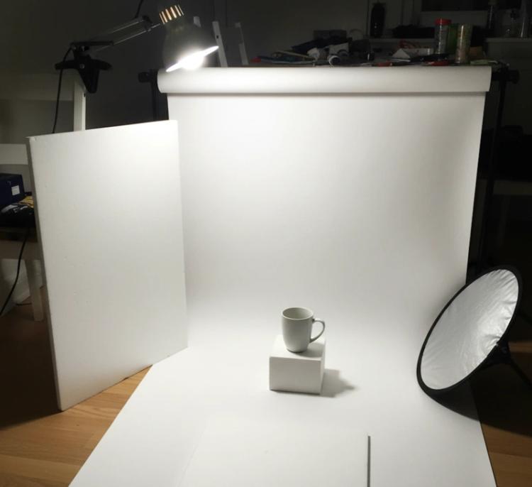 Simple DIY product photography lighting setup with white background and reflectors
