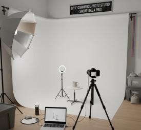 Professional product photography setup with camera, lighting equipment, and white background showing DIY e-commerce photo studio