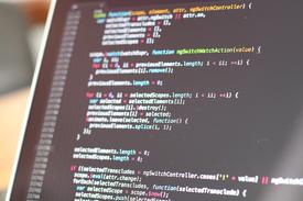 Developer working on cross-platform app optimization with multiple devices showing iOS, Android, and web versions of the same application