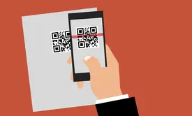 Small business owner scanning QR code for marketing campaign