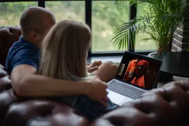 Professional designer working on high-resolution 4K monitor displaying crisp graphics and pixel-perfect images with optimization tools visible on screen