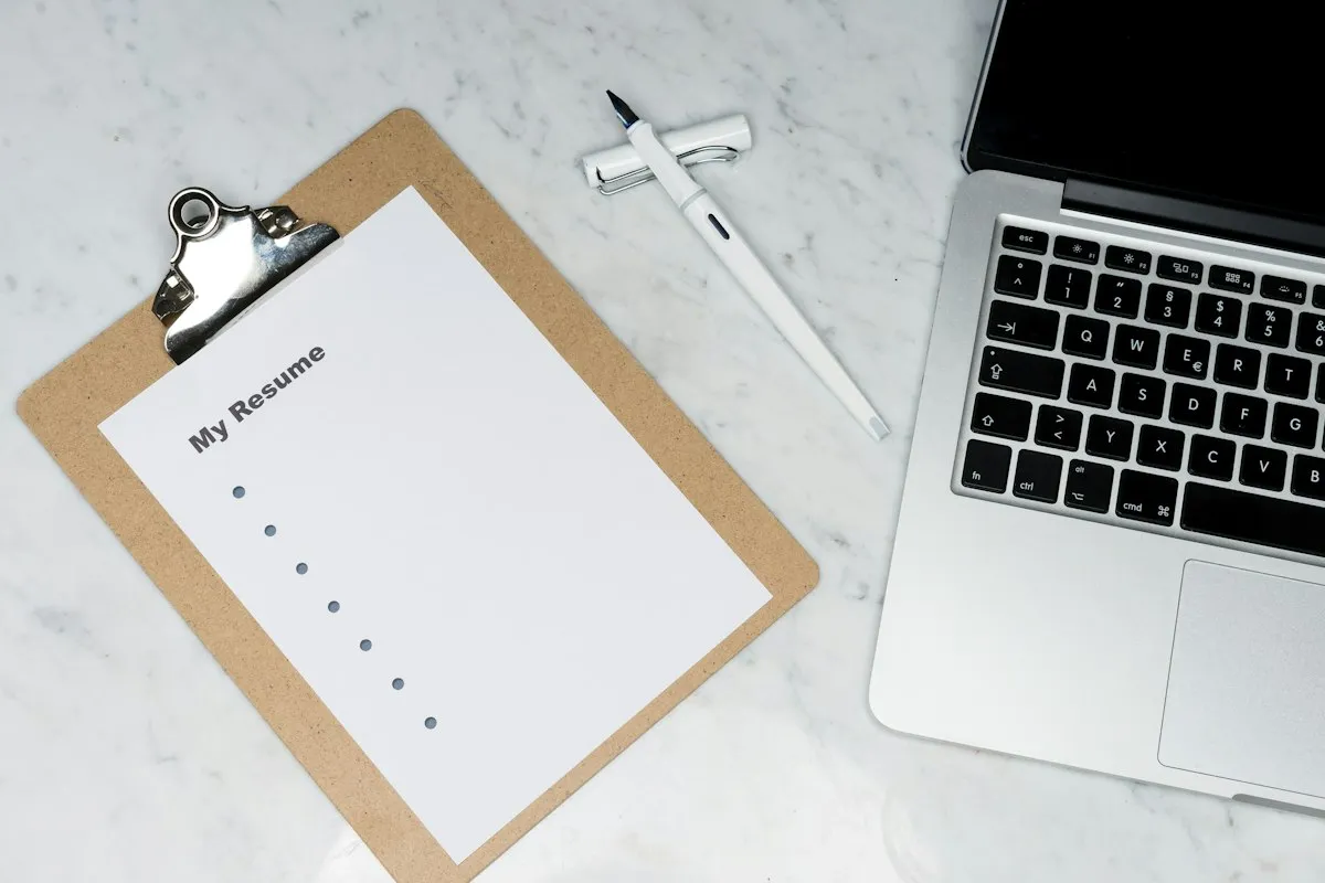 Person planning social media content calendar on laptop with sticky notes and marketing strategy
