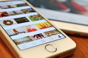 Phone displaying Instagram Reels with engagement metrics rising