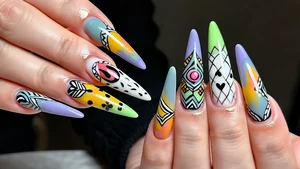 Elegant long acrylic nails featuring detailed artistic designs with vibrant colors