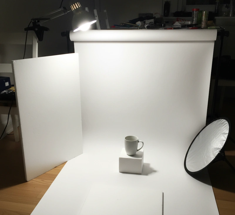 Simple DIY product photography lighting setup with white background and reflectors