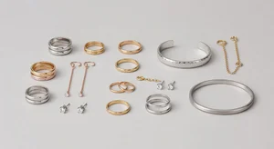 Jewelry collection including rings earrings and bracelet arranged professionally for online store product photography on clean neutral background