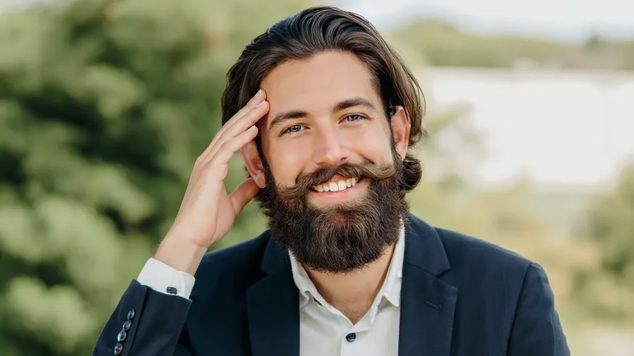Creative professional with fuller artistic beard style in relaxed outdoor setting